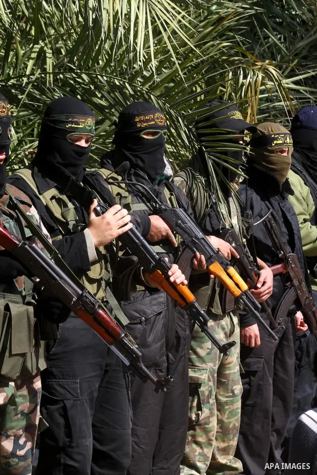 Masked Islamic Jihad militants wait next to the family house of Abeed Shaheen, killed by Israeli shell on Sunday, in Deir al-Balah refugee camp, central Gaza Strip, Monday, Feb. 28, 2011. Photo by Ashraf Amra