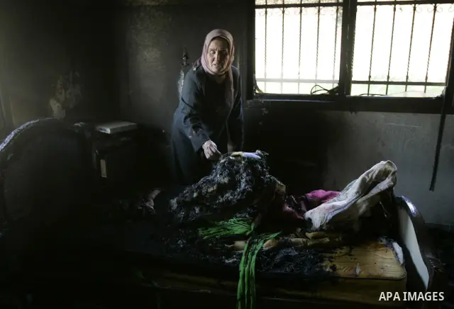 A Palestinian woman looks at a burnt room after her family house was firebombed by Jewish settlers overnight in the West Bank village of Huwwara near Nablus, on March 01, 2011 causing two children to be taken to hospital...