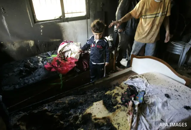 Palestinians look at a burnt room after her family house was firebombed by Jewish settlers overnight in the West Bank village of Huwwara near Nablus, on March 01, 2011 causing two children to be taken to hospital for smo...
