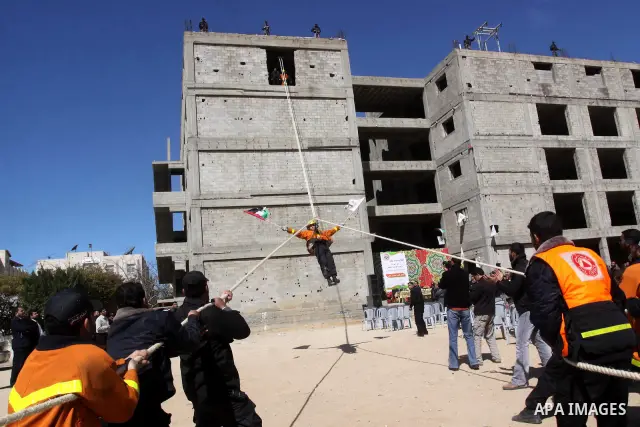 Palestinian civil defense members stage a mock rescue operation during a training exercise marking the International Civil Defense Day in Gaza city on March 2,2011 . Photo by Mohammed Asad