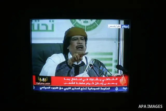 A picture taken from Qatar Al Jazeera state television on March 02, 2011 shows Libyan leader Moammar Qadhafi addressing to the loyalists of his regime during a public rally in Tripoli, as rebels fought back his forces ea...