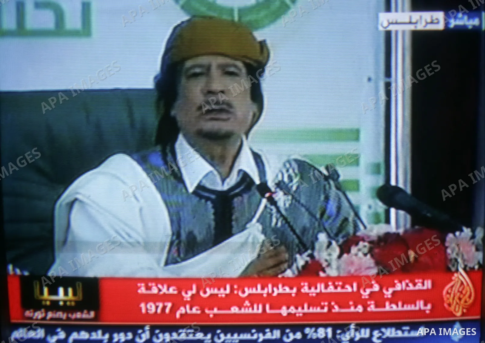 A picture taken from Qatar Al Jazeera state television on March 02, 2011 shows Libyan leader Moammar Qadhafi addressing to the loyalists of his regime during a public rally in Tripoli, as rebels fought back his forces ea...