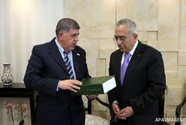 Palestinian Prime Minister, Salam Fayyad receives the report of the office of management and financial controls for 2010, in the West Bank city of Ramallah on March 2, 2011. Photo by Mustafa Abu Dayeh
