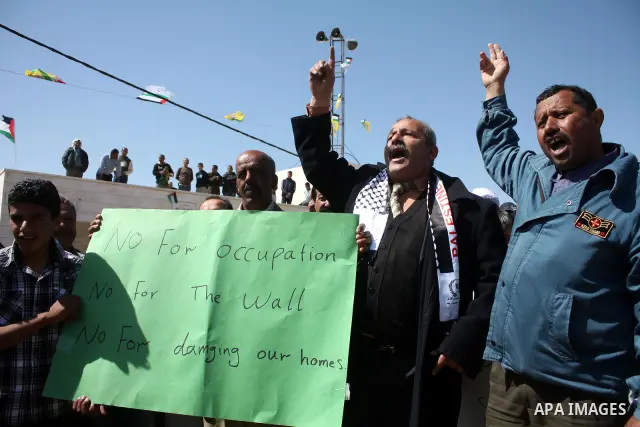 Palestinian take part during demonstration against the decision from Israeli authorities to demolish the mosque ,school and against Israel's controversial separation barrier and calling for the national reconciliation in...