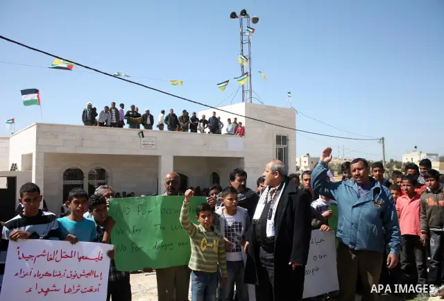 Palestinian take part during demonstration against the decision from Israeli authorities to demolish the mosque ,school and against Israel's controversial separation barrier and calling for the national reconciliation in...