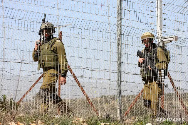 Israeli soldiers stand guards a protest against Israel's controversial separation barrier in the village of Bilin, near the West Bank city of Ramallah, in the Israeli occupied West Bank, on March 4, 2011.photo by Issam R...