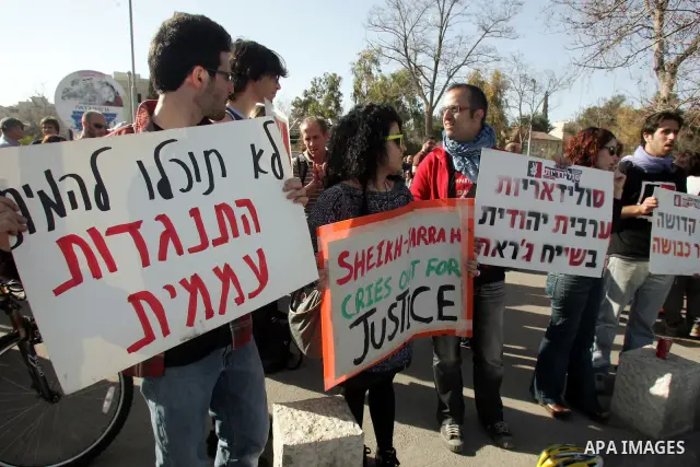 Palestinians and Israeli left-wing activists participate in a demonstration supporting Palestinians evicted from their homes in the east Jerusalem neighborhood of Sheikh Jarrah, Friday, March 4, 2011. Photo by Mahfouz Ab...