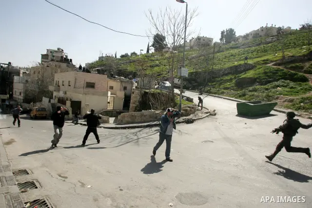 Palestinian youths take positions during clashes with Israeli forces in the east Jerusalem neighborhood of Silwan, Friday, March 4, 2011. Photo by Mahfouz Abu Turk