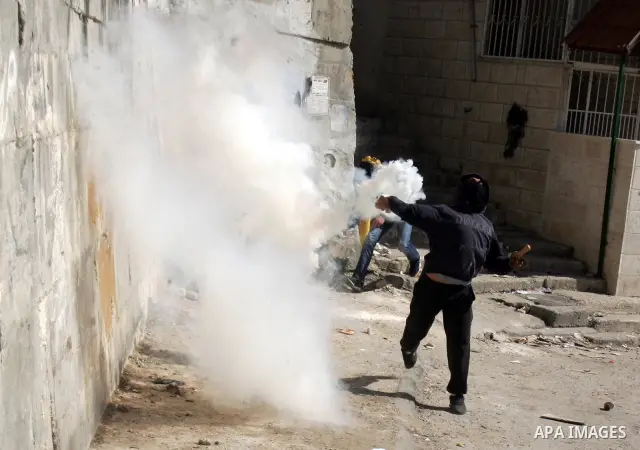 Palestinian youths take positions during clashes with Israeli forces in the east Jerusalem neighborhood of Silwan, Friday, March 4, 2011. Photo by Mahfouz Abu Turk