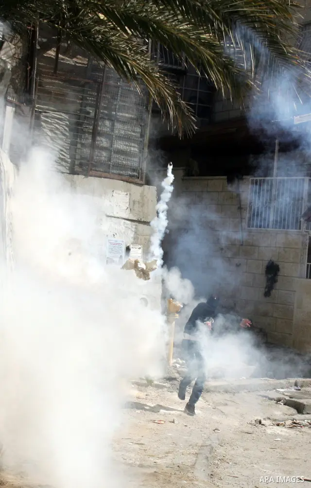 Palestinian youths take positions during clashes with Israeli forces in the east Jerusalem neighborhood of Silwan, Friday, March 4, 2011. Photo by Mahfouz Abu Turk
