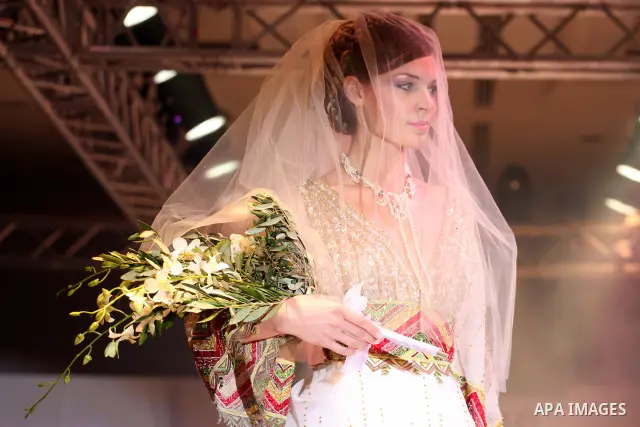 A model takes the catwalk wearing a design by Palestinian fashion designer Jamal Taslaq during a fashion show sponsored by the Italian Consulate-General and the Palestinian Ministry of Culture as part of a wedding fair i...