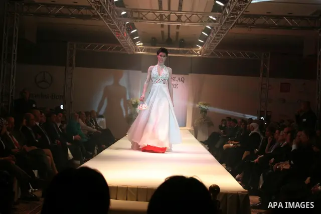 A model takes the catwalk wearing a design by Palestinian fashion designer Jamal Taslaq during a fashion show sponsored by the Italian Consulate-General and the Palestinian Ministry of Culture as part of a wedding fair i...