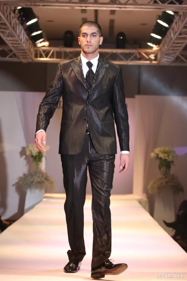 A model takes the catwalk wearing a design by Palestinian fashion designer Jamal Taslaq during a fashion show sponsored by the Italian Consulate-General and the Palestinian Ministry of Culture as part of a wedding fair i...