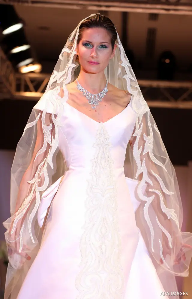 A model takes the catwalk wearing a design by Palestinian fashion designer Jamal Taslaq during a fashion show sponsored by the Italian Consulate-General and the Palestinian Ministry of Culture as part of a wedding fair i...