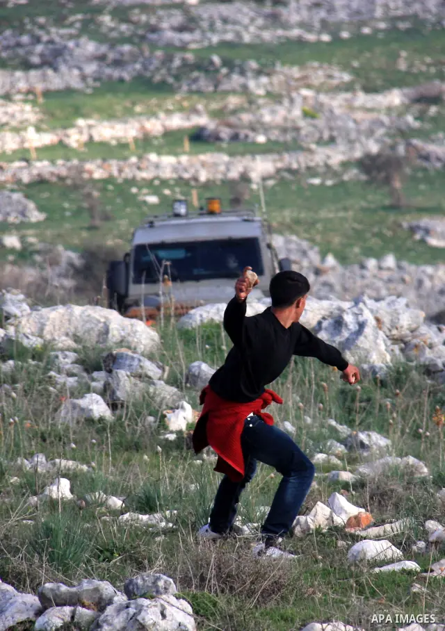 Palestinian protestors hurl stones at Israeli troops in the West Bank village of Iraq Borin near Nablus, on 05 March 2011. Two Palestinians were wounded after Israeli troops raided the village to stop clashes between Pal...