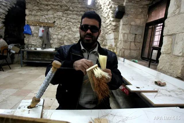 Palestinian blind men work in making brooms at a workshop in the Old City of Jerusalem on March 5,2011. The workshop is owned and managed by the Arab Blind Association, which was founded by blind Palestinians in 1932, an...