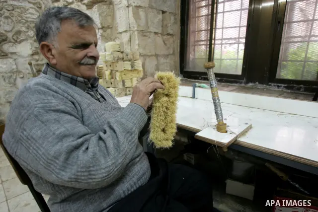 Palestinian blind men work in making brooms at a workshop in the Old City of Jerusalem on March 5,2011. The workshop is owned and managed by the Arab Blind Association, which was founded by blind Palestinians in 1932, an...
