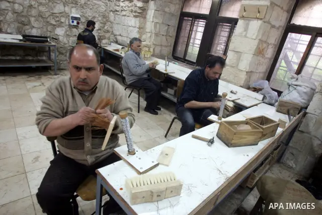 Palestinian blind men work in making brooms at a workshop in the Old City of Jerusalem on March 5,2011. The workshop is owned and managed by the Arab Blind Association, which was founded by blind Palestinians in 1932, an...