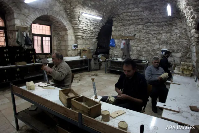 Palestinian blind men work in making brooms at a workshop in the Old City of Jerusalem on March 5,2011. The workshop is owned and managed by the Arab Blind Association, which was founded by blind Palestinians in 1932, an...