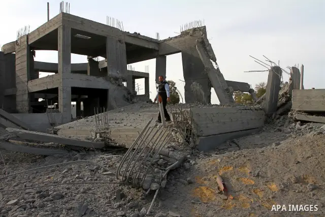 A Palestinian man inspects the damage to a building still under construction and belonging to the Islamic University, following an overnight Israeli air raid, south of Gaza City, on March 6, 2011. Photo by Ashraf Amra