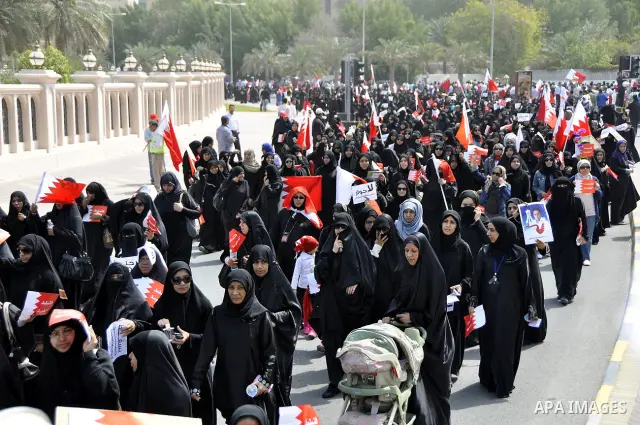 Bahraini anti-government protesters chant slogans Sunday, March 6, 2011, as thousands circle the Gudaibiya Palace compound in Manama, Bahrain, where the office of Prime Minister Khalifa bin Salman Al Khalifa is located....