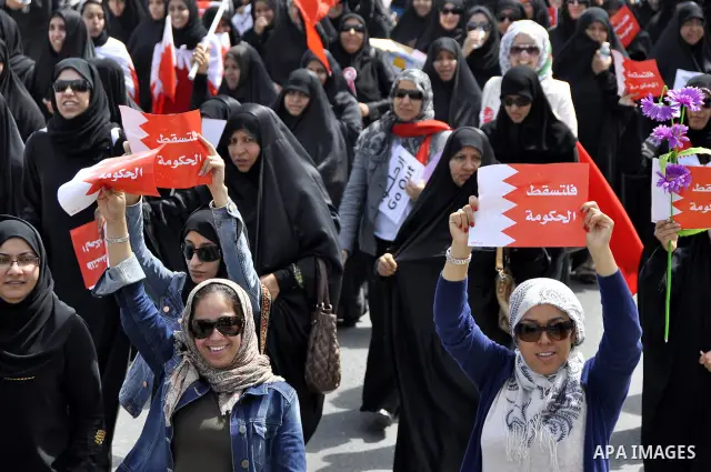 Bahraini anti-government protesters chant slogans Sunday, March 6, 2011, as thousands circle the Gudaibiya Palace compound in Manama, Bahrain, where the office of Prime Minister Khalifa bin Salman Al Khalifa is located....