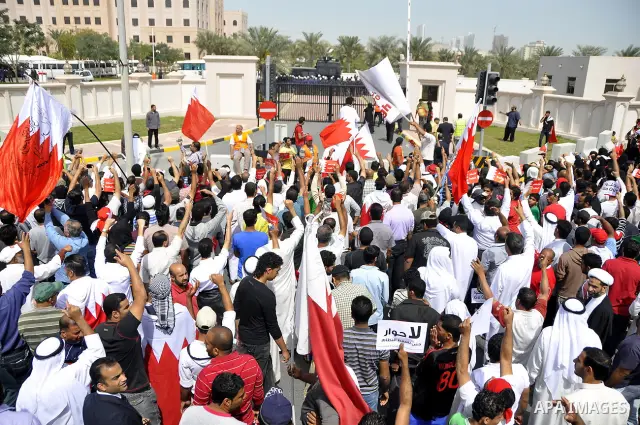 Bahraini anti-government protesters chant slogans Sunday, March 6, 2011, as thousands circle the Gudaibiya Palace compound in Manama, Bahrain, where the office of Prime Minister Khalifa bin Salman Al Khalifa is located....