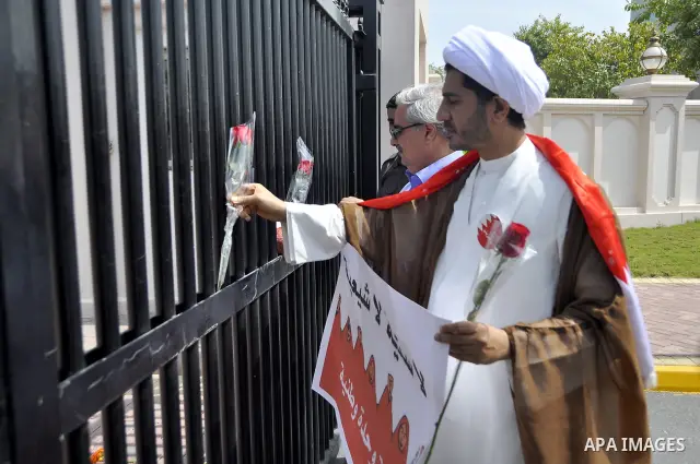 Bahraini anti-government protesters take part in a demonstration, Sunday, March 6, 2011, as thousands circle the Gudaibiya Palace compound in Manama, Bahrain, where the office of Prime Minister Khalifa bin Salman Al Khal...
