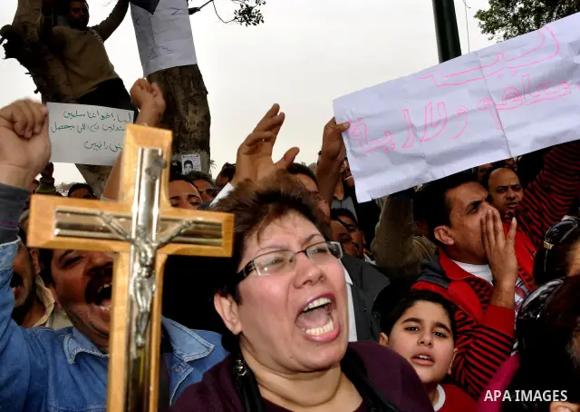 Egyptian christian protesters take part in a demonstration after burning a church in Hilwan, in front of the state television building headquarters in Cairo, Egypt, Sunday, March 6, 2011. Three weeks after President Hosn...
