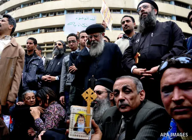 Egyptian christian protesters take part in a demonstration after burning a church in Hilwan, in front of the state television building headquarters in Cairo, Egypt, Sunday, March 6, 2011. Three weeks after President Hosn...