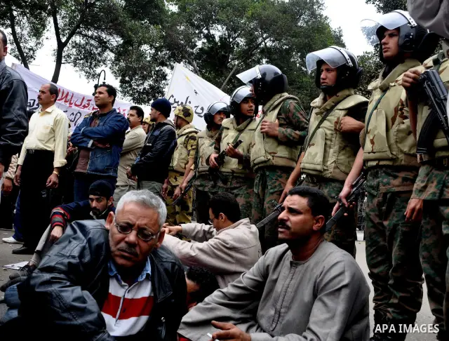 Egyptian christian protesters take part in a demonstration after burning a church in Hilwan, in front of the state television building headquarters in Cairo, Egypt, Sunday, March 6, 2011. Three weeks after President Hosn...