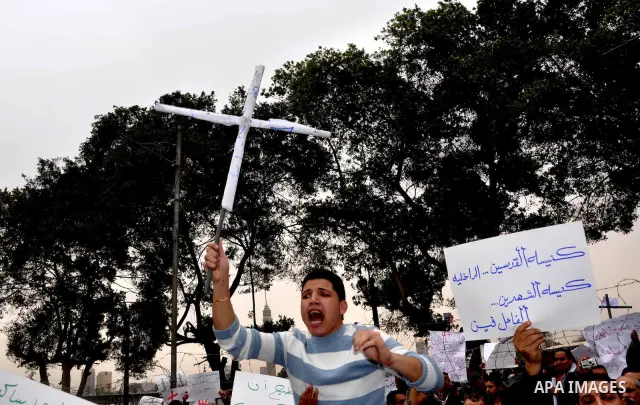 Egyptian christian protesters take part in a demonstration after burning a church in Hilwan, in front of the state television building headquarters in Cairo, Egypt, Sunday, March 6, 2011. Three weeks after President Hosn...