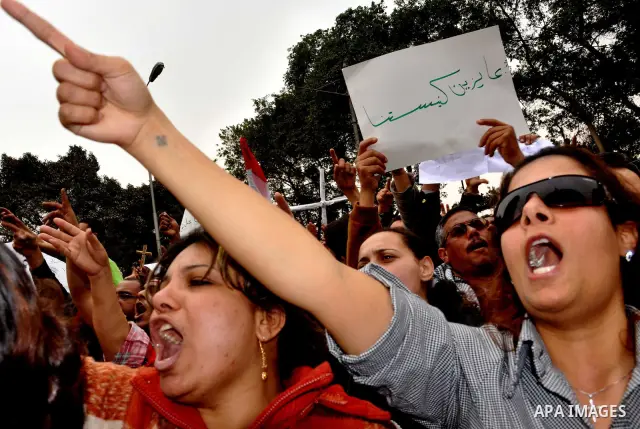Egyptian christian protesters take part in a demonstration after burning a church in Hilwan, in front of the state television building headquarters in Cairo, Egypt, Sunday, March 6, 2011. Three weeks after President Hosn...