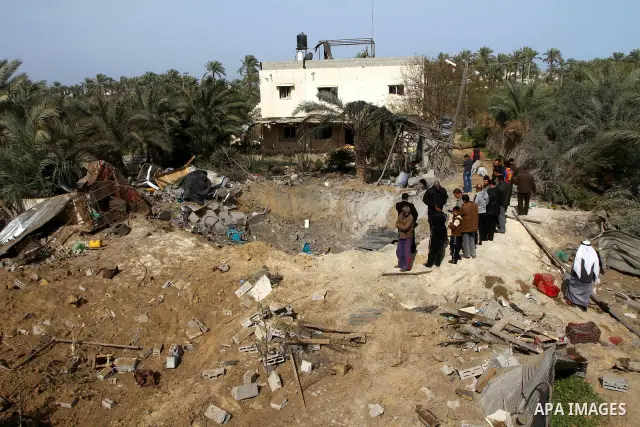 Palestinians inspect the damage following an Israeli airstrike in Deir al-Balah refugee camp, southern Gaza Strip, Sunday, March 6, 2011. Photo by Ashraf Amra