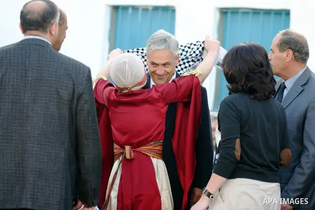 Chilean President Sebastian Pinera and his wife Cecilia Morel are greeted by Palestinian during their arrival at the Church of the Nativity, the site revered as the birthplace of Jesus, in the West Bank town of Bethlehem...