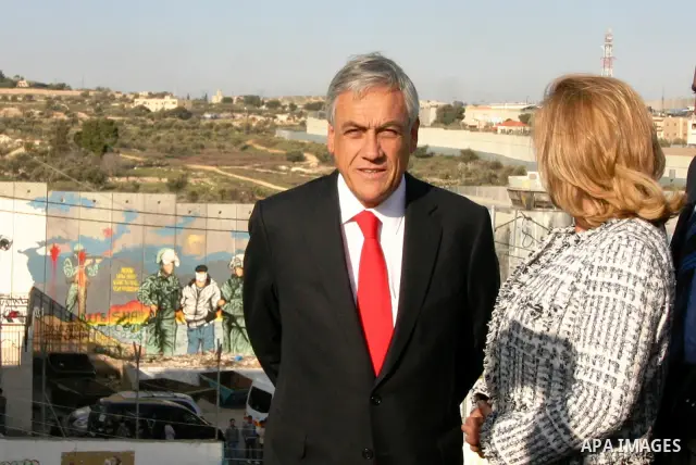 Chilean President Sebastian Pinera and his wife Cecilia Morel are greeted by Palestinian during their arrival at the Church of the Nativity, the site revered as the birthplace of Jesus, in the West Bank town of Bethlehem...