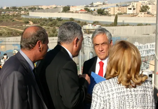 Chilean President Sebastian Pinera and his wife Cecilia Morel are greeted by Palestinian during their arrival at the Church of the Nativity, the site revered as the birthplace of Jesus, in the West Bank town of Bethlehem...
