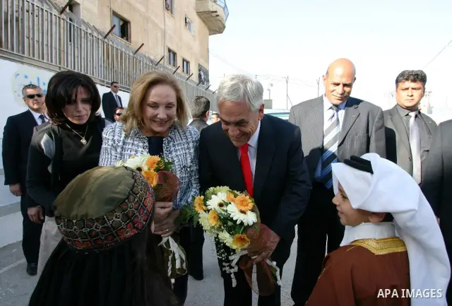 Chilean President Sebastian Pinera and his wife Cecilia Morel are greeted by Palestinian during their arrival at the Church of the Nativity, the site revered as the birthplace of Jesus, in the West Bank town of Bethlehem...