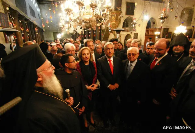 Chilean President Sebastian Pinera and his wife Cecilia Morel are greeted by Palestinian during their arrival at the Church of the Nativity, the site revered as the birthplace of Jesus, in the West Bank town of Bethlehem...
