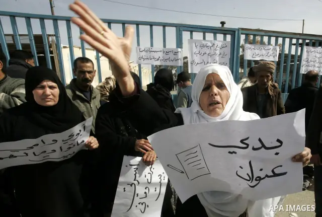 Palestinians protest outside the UNRWA headquarters in the southern Gaza Strip Rafah refugee camp on March 6, 2011, calling for implementation of the United Nations decision to construct the houses which were destroyed d...