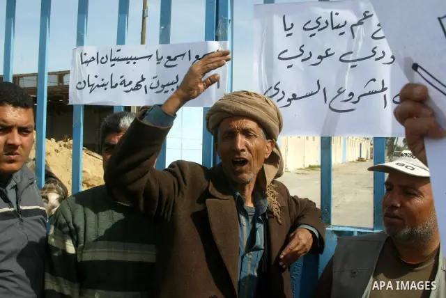 Palestinians protest outside the UNRWA headquarters in the southern Gaza Strip Rafah refugee camp on March 6, 2011, calling for implementation of the United Nations decision to construct the houses which were destroyed d...