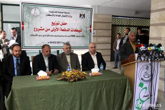 Palestinian members of the Ministry of Works and Housing attend a celebration to distribute checks for the Palestinians who lost their houses during the Israeli war on Gaza Strip, in Gaza city on March 6,2011. Photo by M...