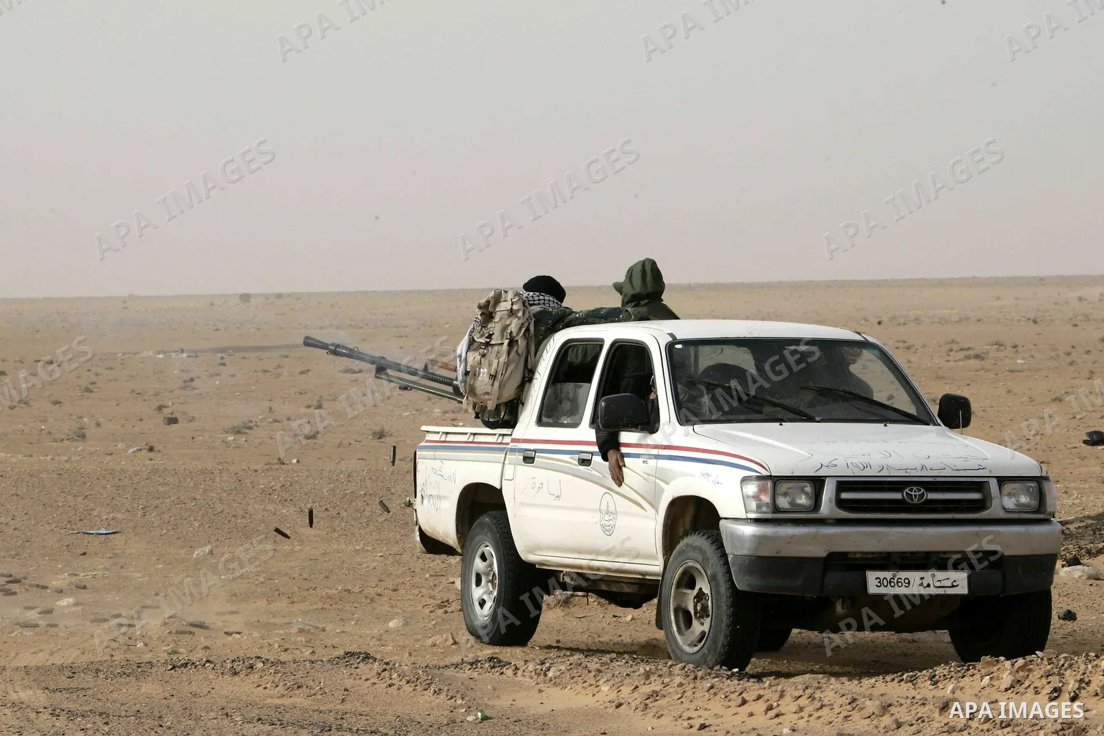 Rebel fighters return fire during shelling by soldiers loyal to Libyan leader Muammar Gaddafi in a battle near Ras Lanuf, March 4, 2011. Heavily armed rebels clashed with forces loyal to Gaddafi on Friday on the outskirt...