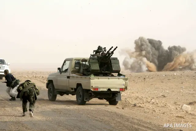 Rebel fighters take cover from shelling by soldiers loyal to Libyan leader Muammar Gaddafi during a battle near Ras Lanuf, March 4, 2011. Heavily armed rebels clashed with forces loyal to Gaddafi on Friday on the outskir...