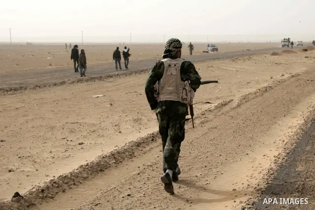 Rebel fighters return fire during shelling by soldiers loyal to Libyan leader Muammar Gaddafi in a battle near Ras Lanuf, March 4, 2011. Heavily armed rebels clashed with forces loyal to Gaddafi on Friday on the outskirt...