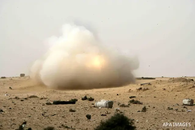 Rebel fighters return fire during shelling by soldiers loyal to Libyan leader Muammar Gaddafi in a battle near Ras Lanuf, March 4, 2011. Heavily armed rebels clashed with forces loyal to Gaddafi on Friday on the outskirt...