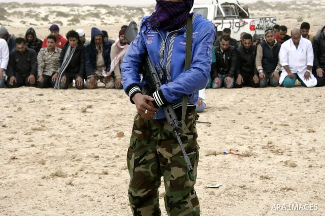 Rebel fighters return fire during shelling by soldiers loyal to Libyan leader Muammar Gaddafi in a battle near Ras Lanuf, March 4, 2011. Heavily armed rebels clashed with forces loyal to Gaddafi on Friday on the outskirt...