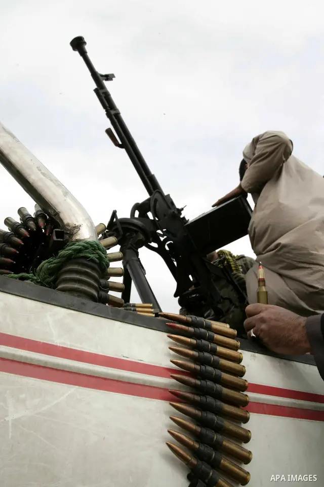 Rebel fighters return fire during shelling by soldiers loyal to Libyan leader Muammar Gaddafi in a battle near Ras Lanuf, March 4, 2011. Heavily armed rebels clashed with forces loyal to Gaddafi on Friday on the outskirt...