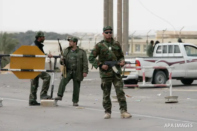 Rebel fighters return fire during shelling by soldiers loyal to Libyan leader Muammar Gaddafi in a battle near Ras Lanuf, March 4, 2011. Heavily armed rebels clashed with forces loyal to Gaddafi on Friday on the outskirt...