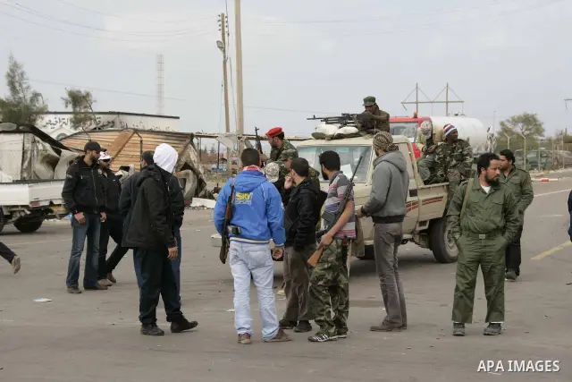 Rebel fighters return fire during shelling by soldiers loyal to Libyan leader Muammar Gaddafi in a battle near Ras Lanuf, March 4, 2011. Heavily armed rebels clashed with forces loyal to Gaddafi on Friday on the outskirt...